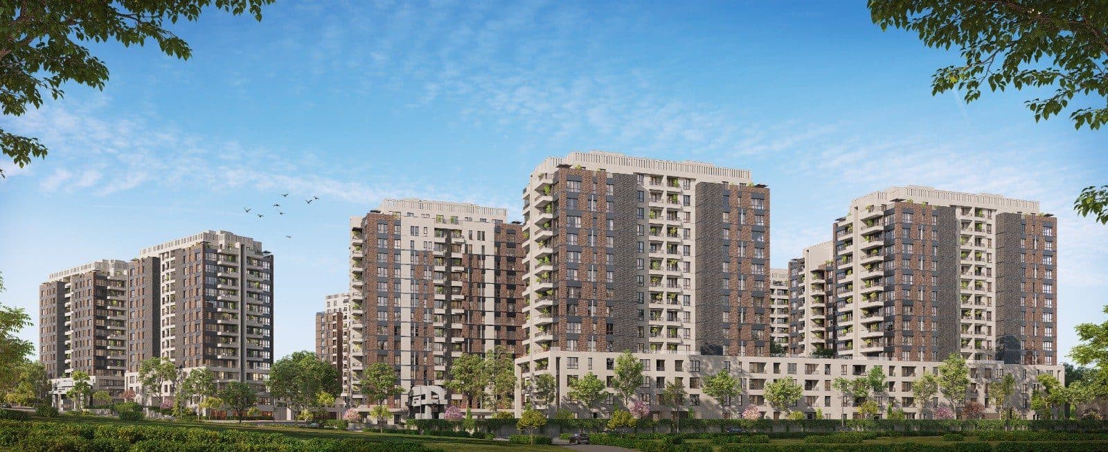 Panoramic view of the complex's residential blocks rising behind a low-rise podium and a row of trees
