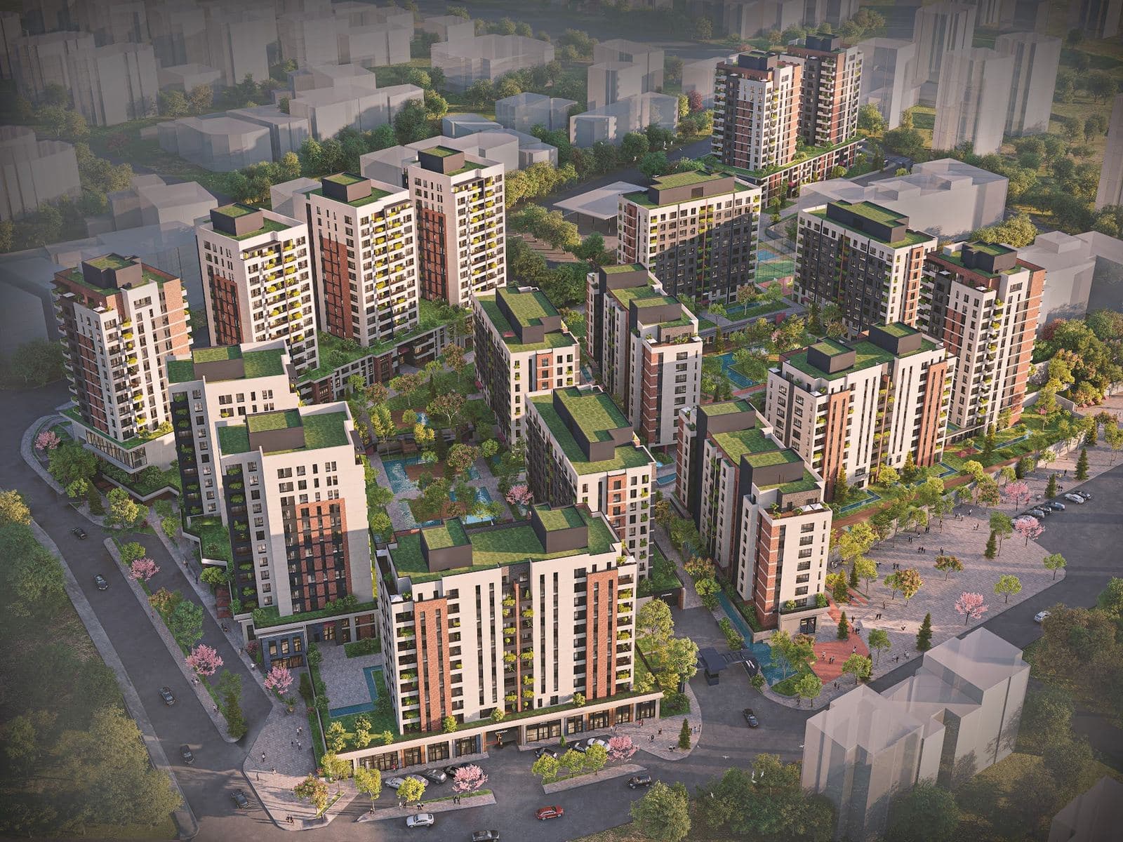 Aerial view of the Avrupa Konutlari Yenimahalle blocks set around landscaped courtyards, with shops along the surrounding streets