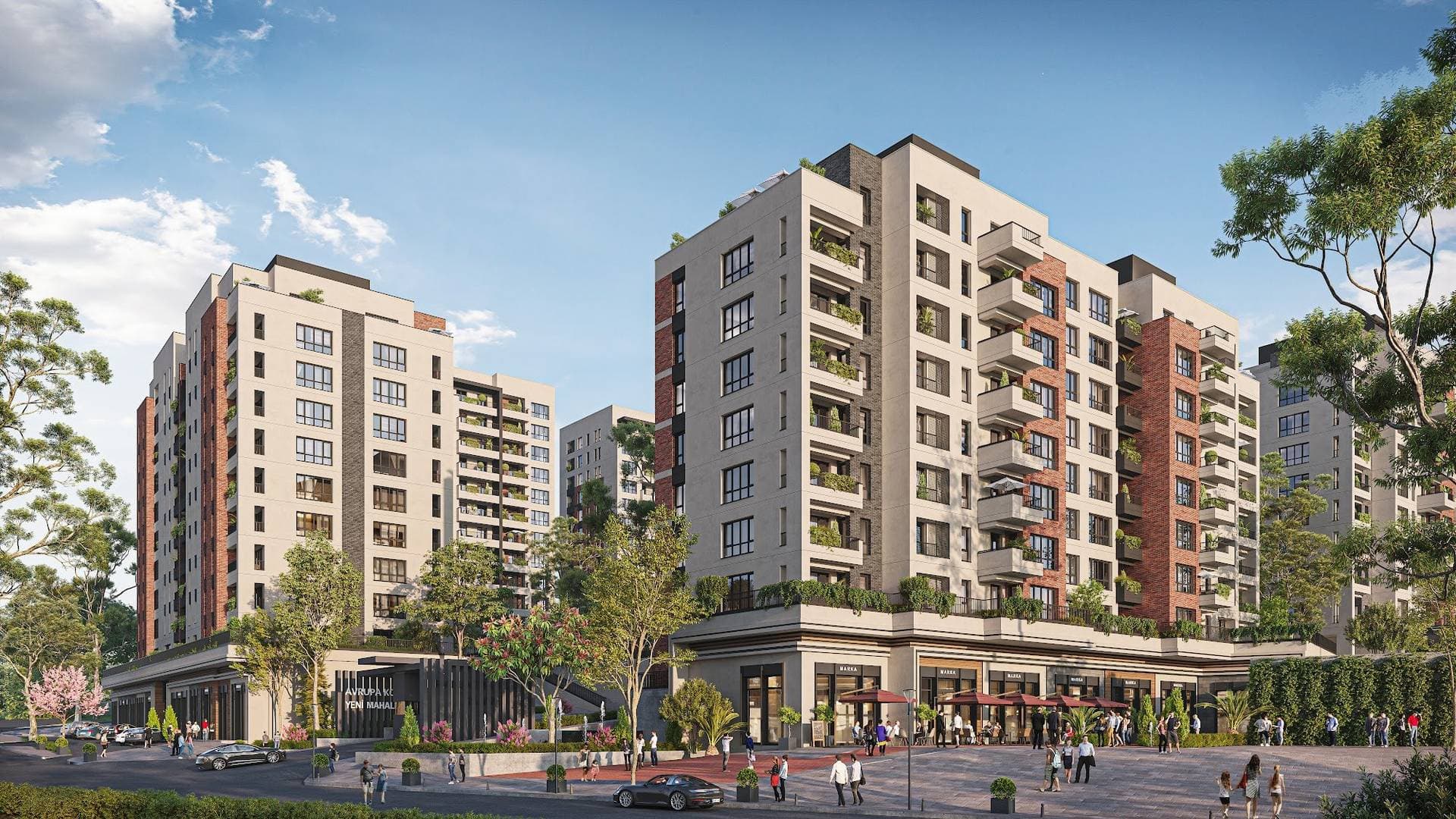 Two residential blocks above street-front shops and cafes at a corner of the complex, with the project entrance between them