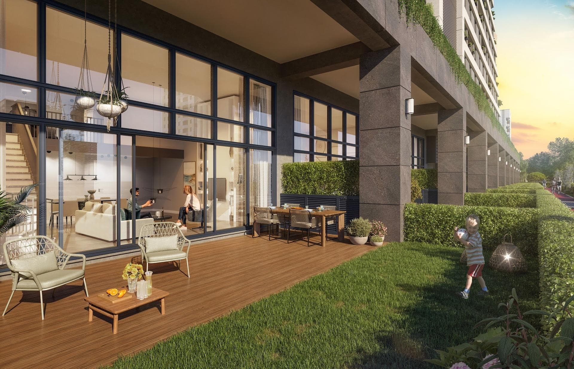 Ground-level loft apartment with double-height glazing opening onto a timber deck and a private lawn