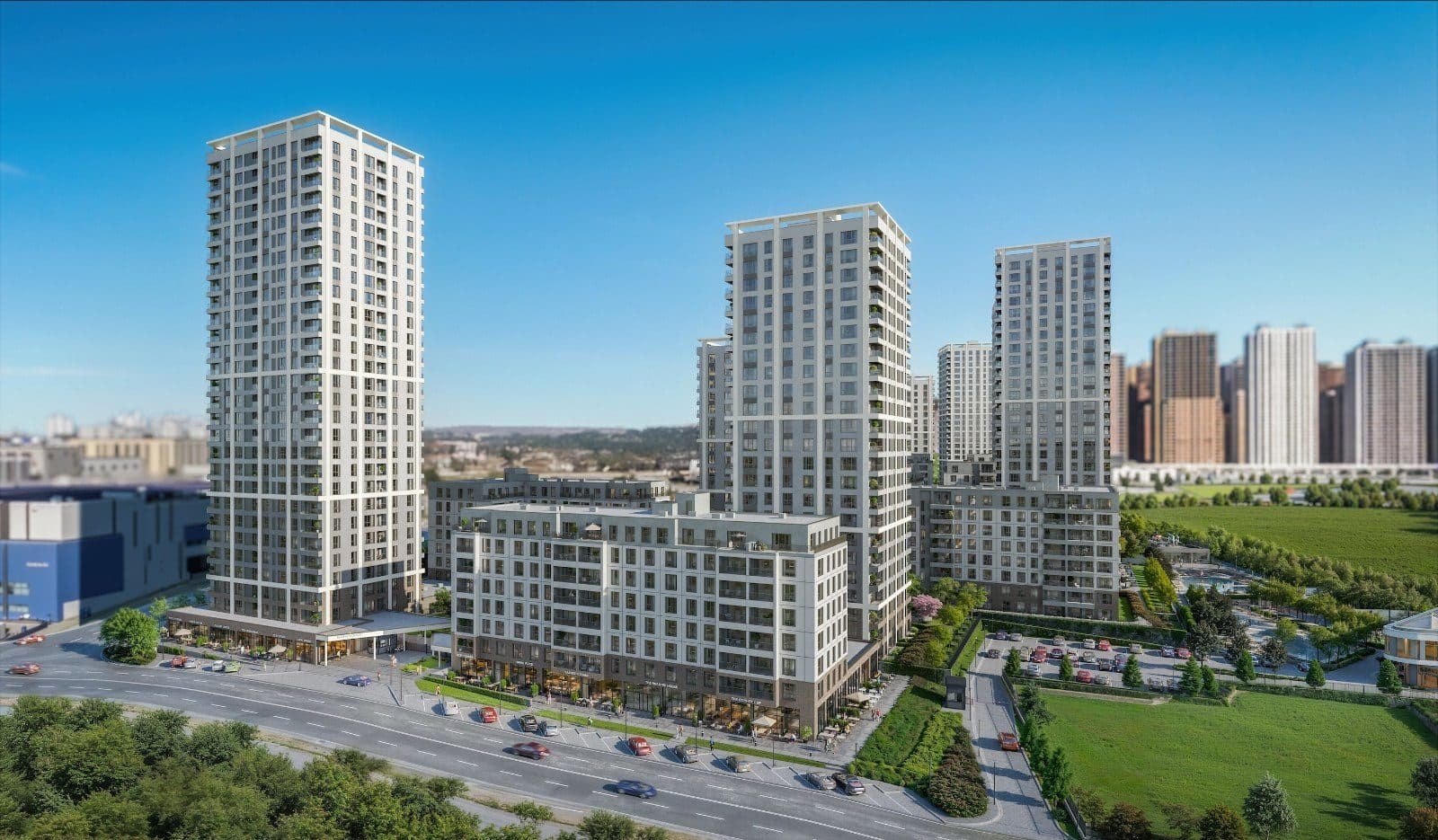 Tall towers and a lower residential block along the street at the edge of the site