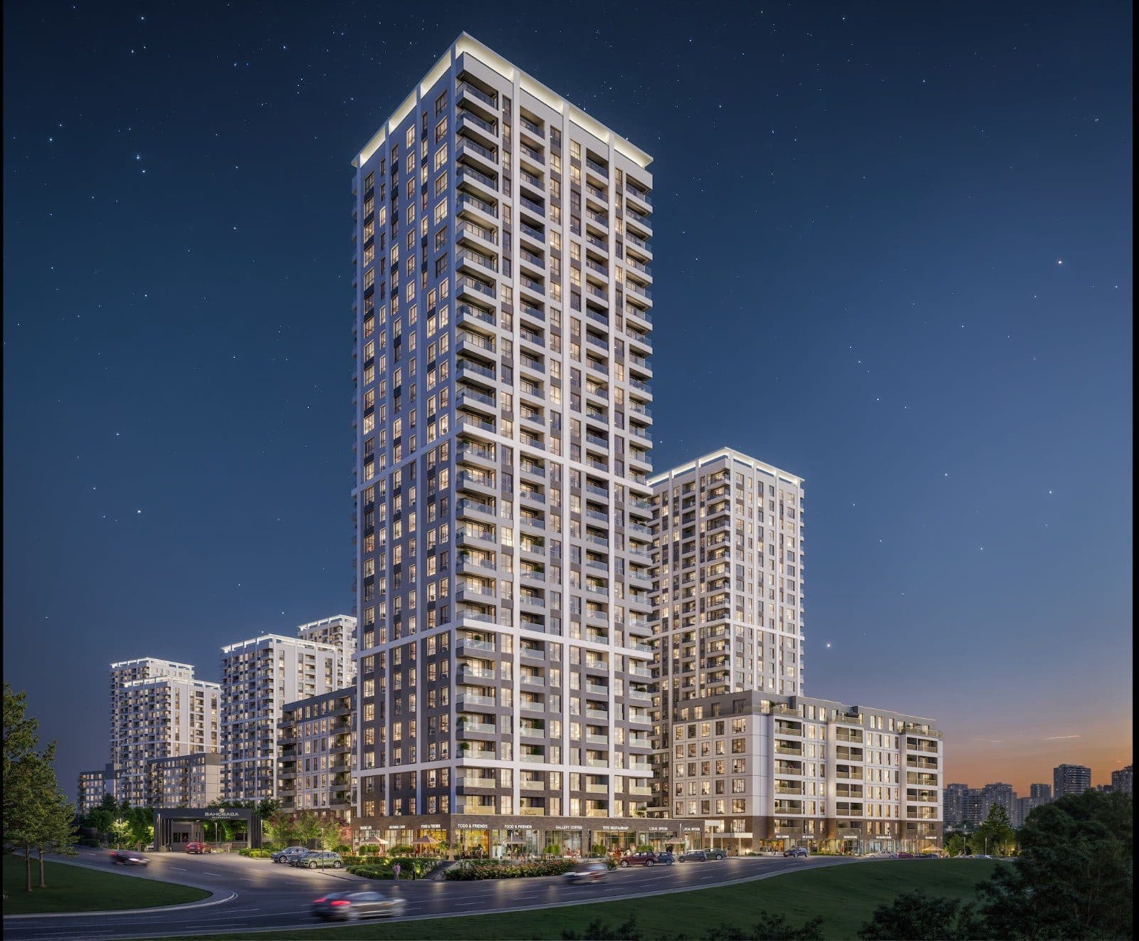 The tallest tower and neighboring blocks lit up at dusk