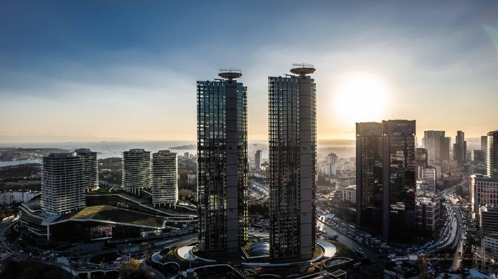 The two towers rising from their landscaped podium in Zincirlikuyu in the late afternoon sun