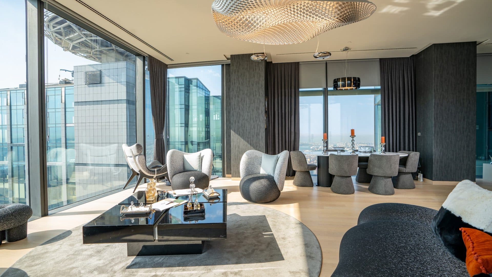 Furnished living and dining room with floor-to-ceiling windows on a high floor