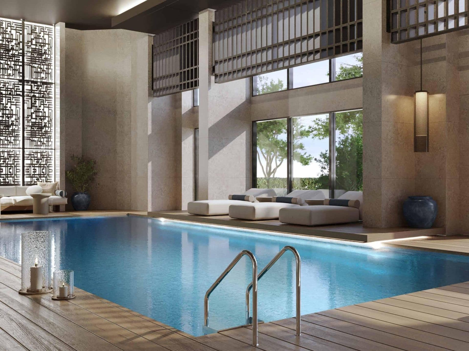 Indoor swimming pool with loungers and tall windows onto the garden