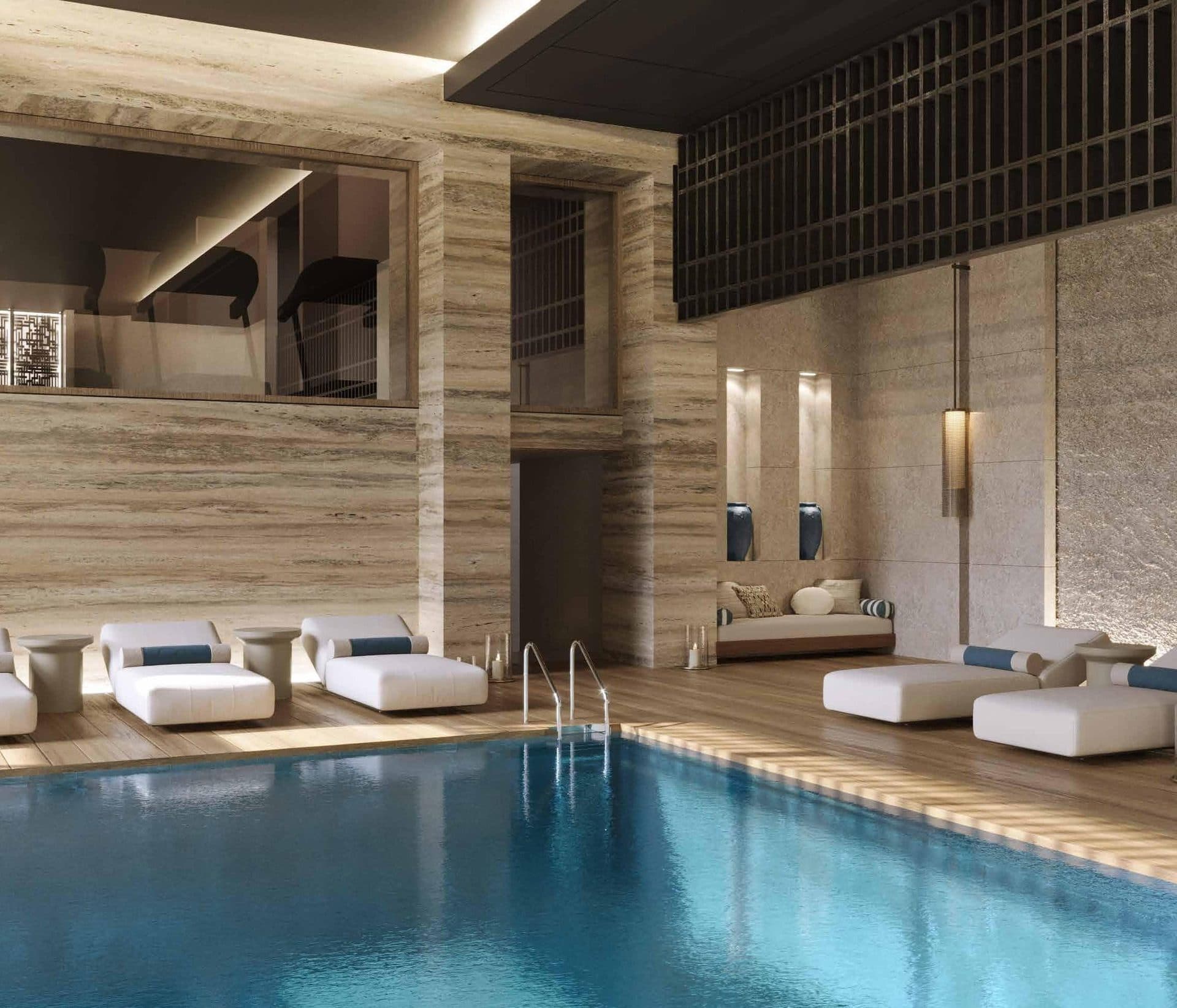 Lounge area with daybeds beside the indoor pool