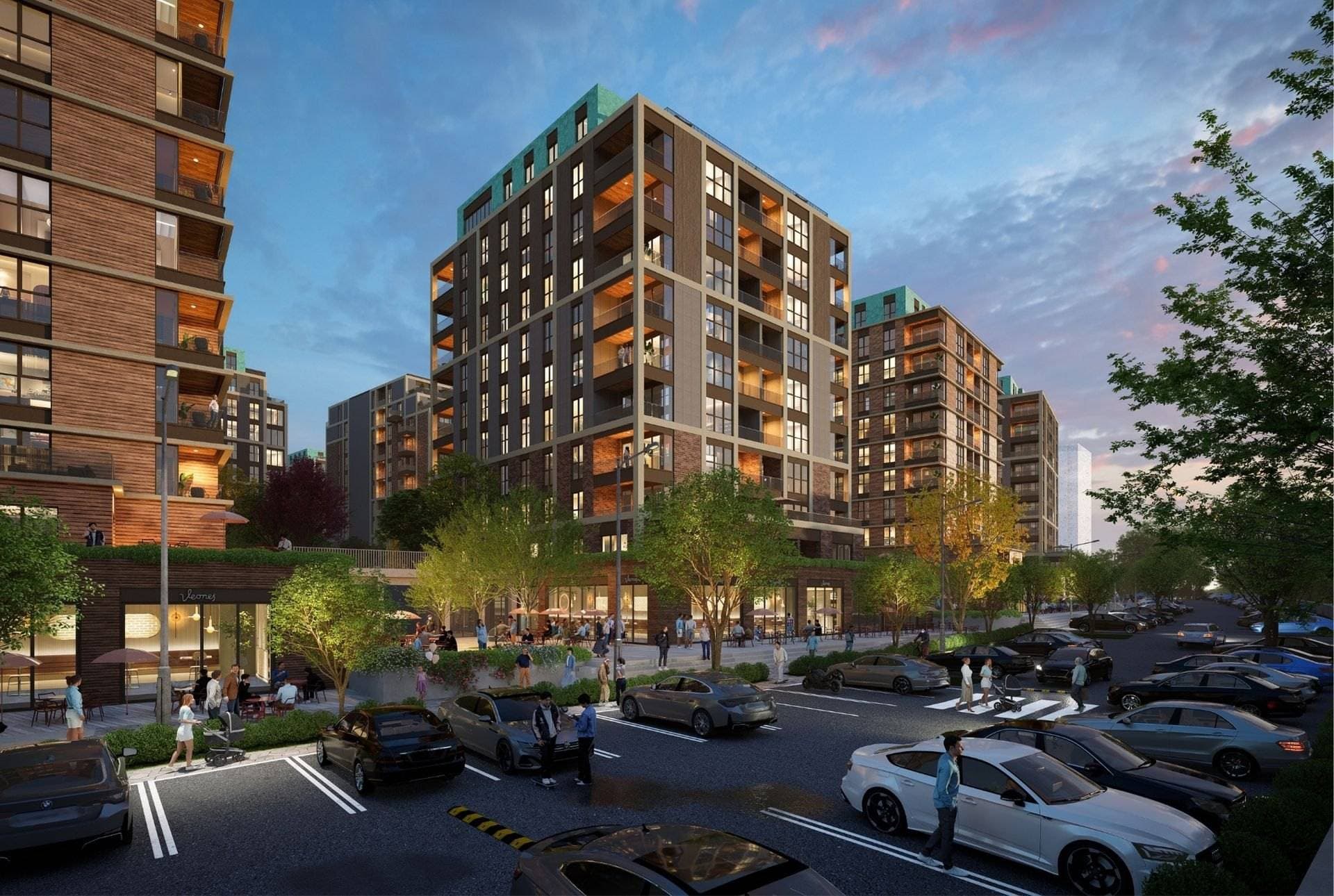 Dusk render of street-level shops and cafes beneath the residential blocks, with parking along the road