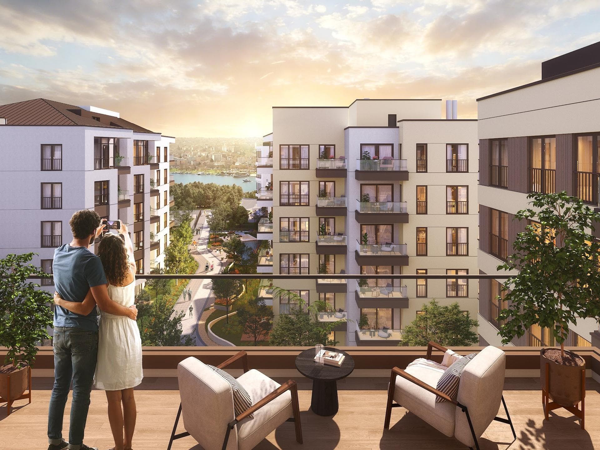 Couple on a terrace looking over the courtyard and residential blocks towards the Golden Horn at sunset