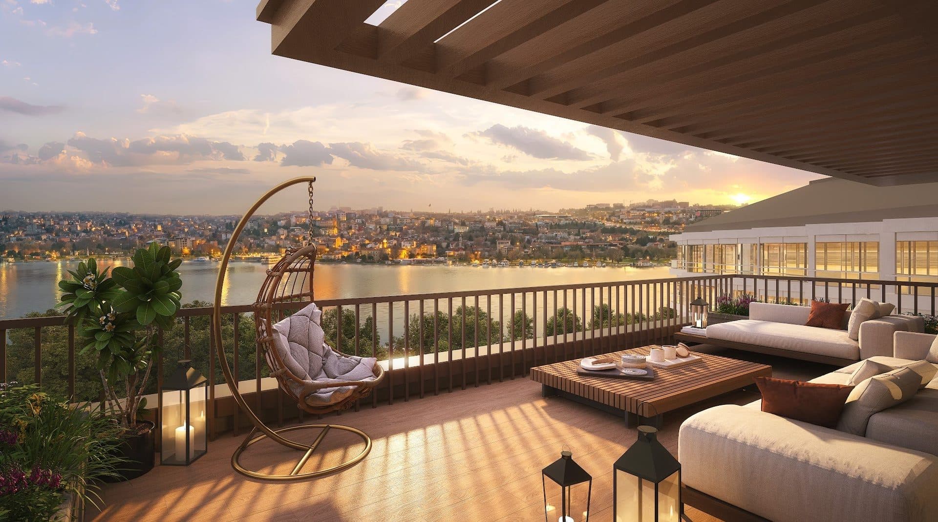 Covered roof terrace with sofas and a hanging chair overlooking the Golden Horn at sunset