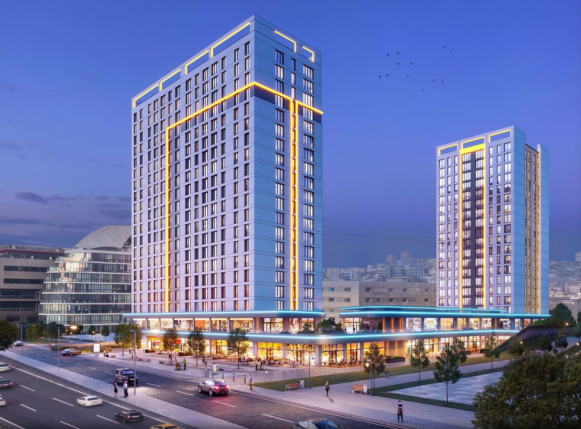 Rendering of the two towers at dusk, the taller one outlined in yellow light, above a glowing podium of shops and cafes along a busy street