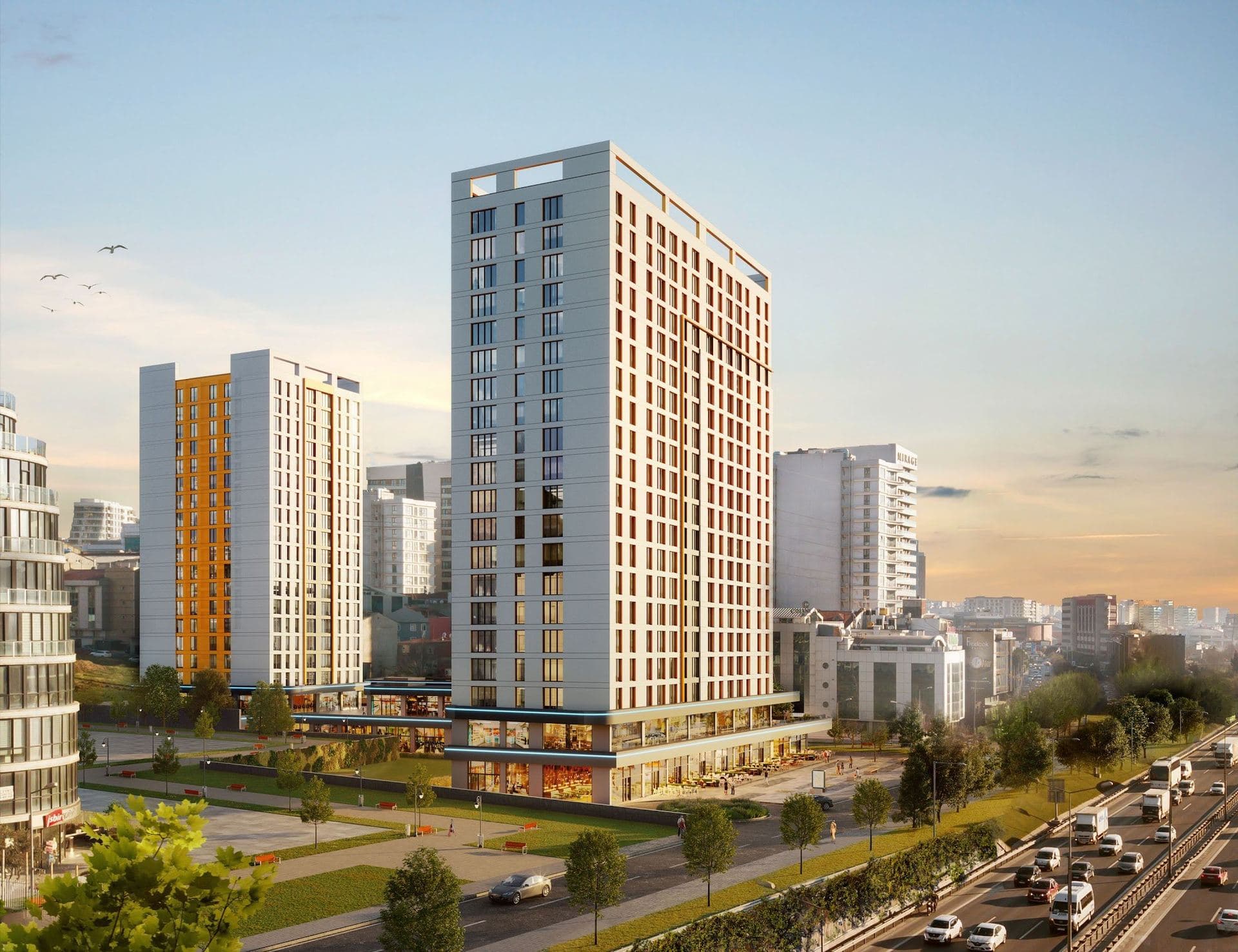 Rendering of the two towers in evening light, with ground-floor shops and a tree-lined walkway beside the motorway