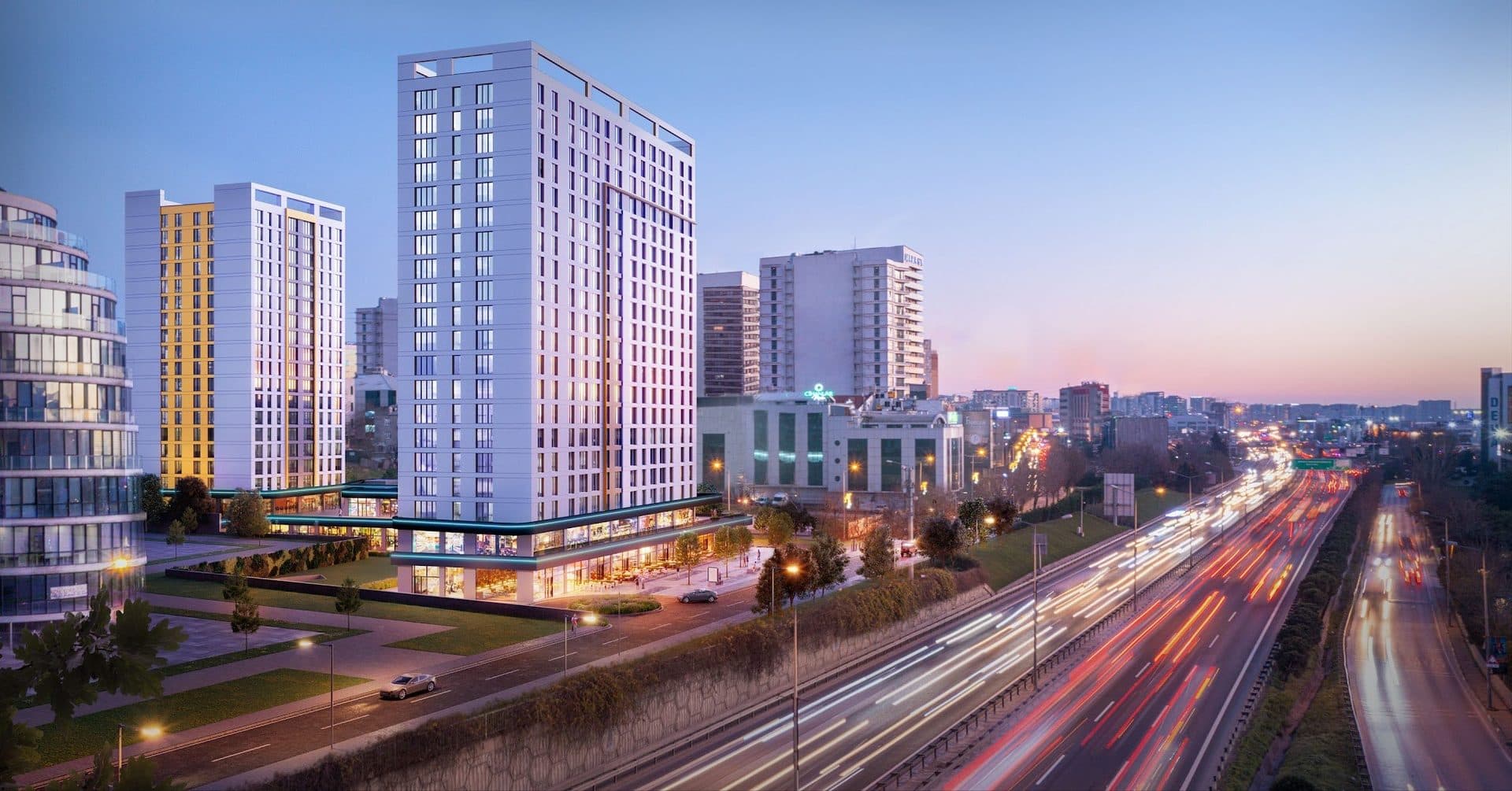Rendering of the towers at dusk beside the Basin Ekspres motorway, with light trails from the traffic