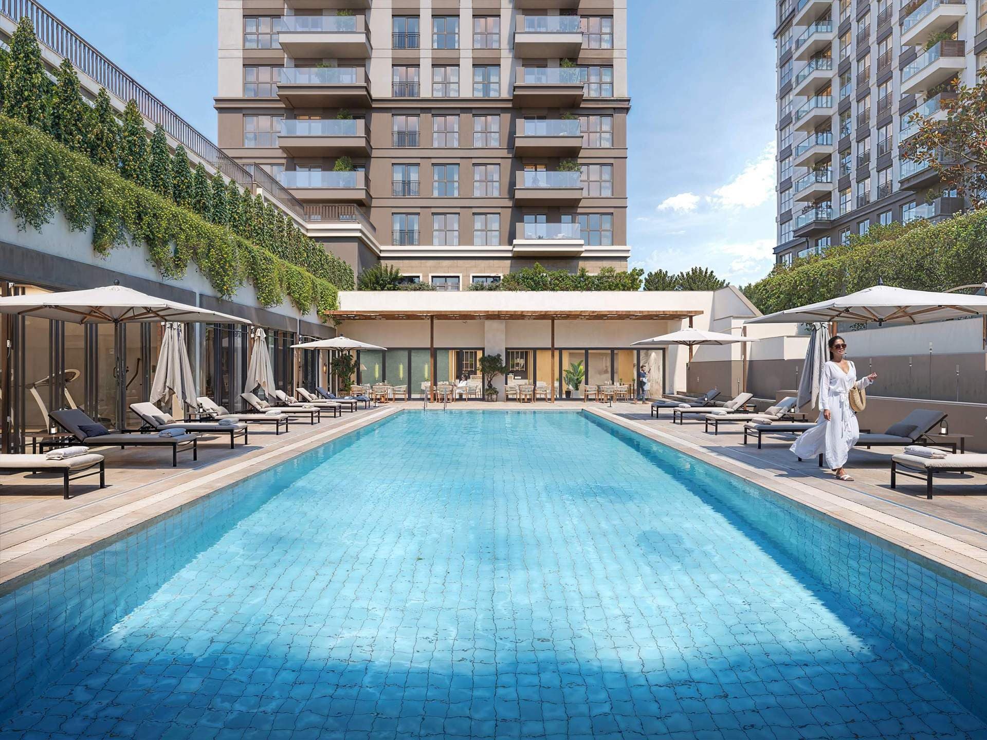 Outdoor swimming pool with sun loungers at Hayat Flora