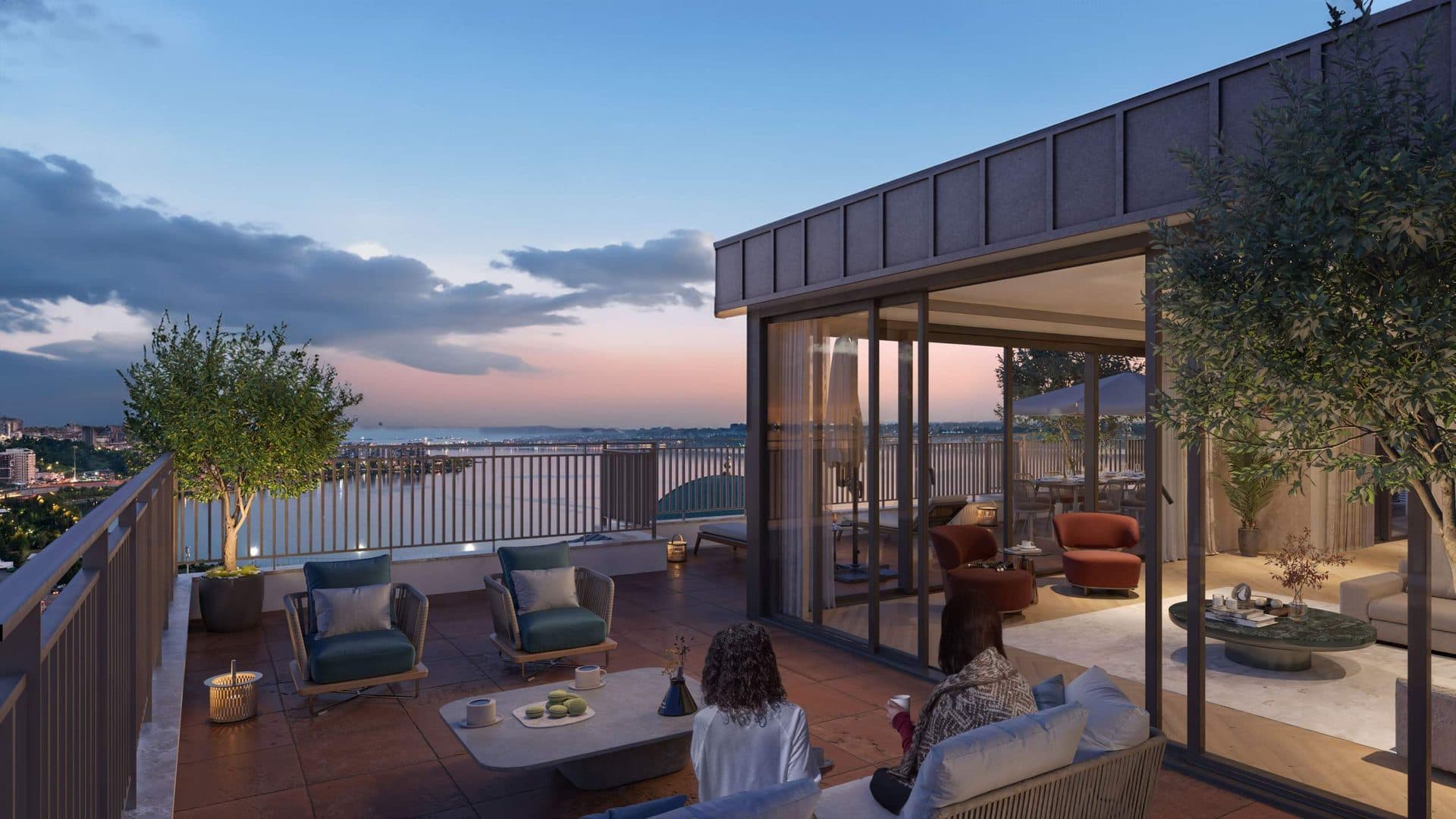 Roof terrace of a duplex apartment overlooking the water at dusk
