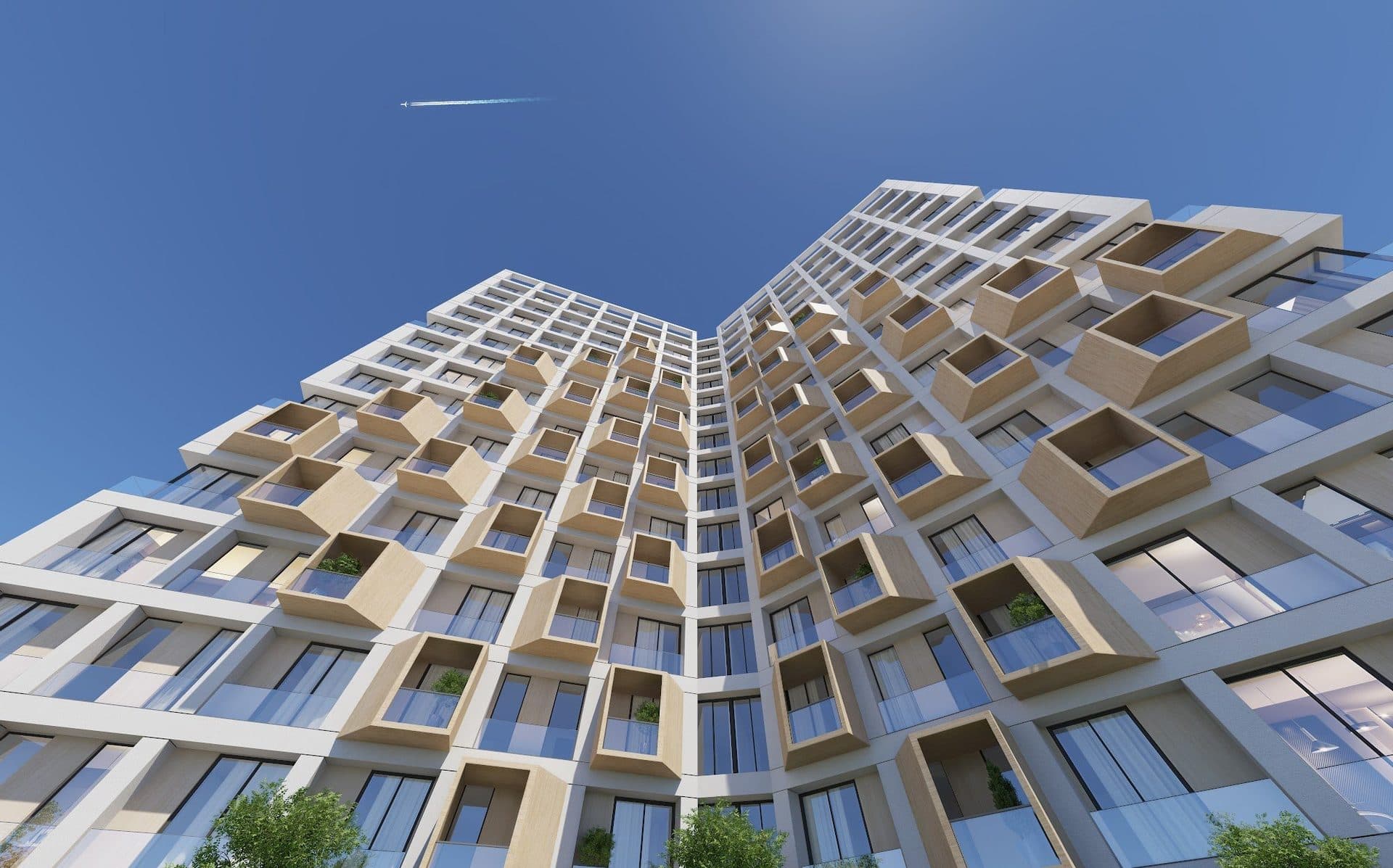 Render looking up at the tower, its two wings meeting at an angle against a blue sky