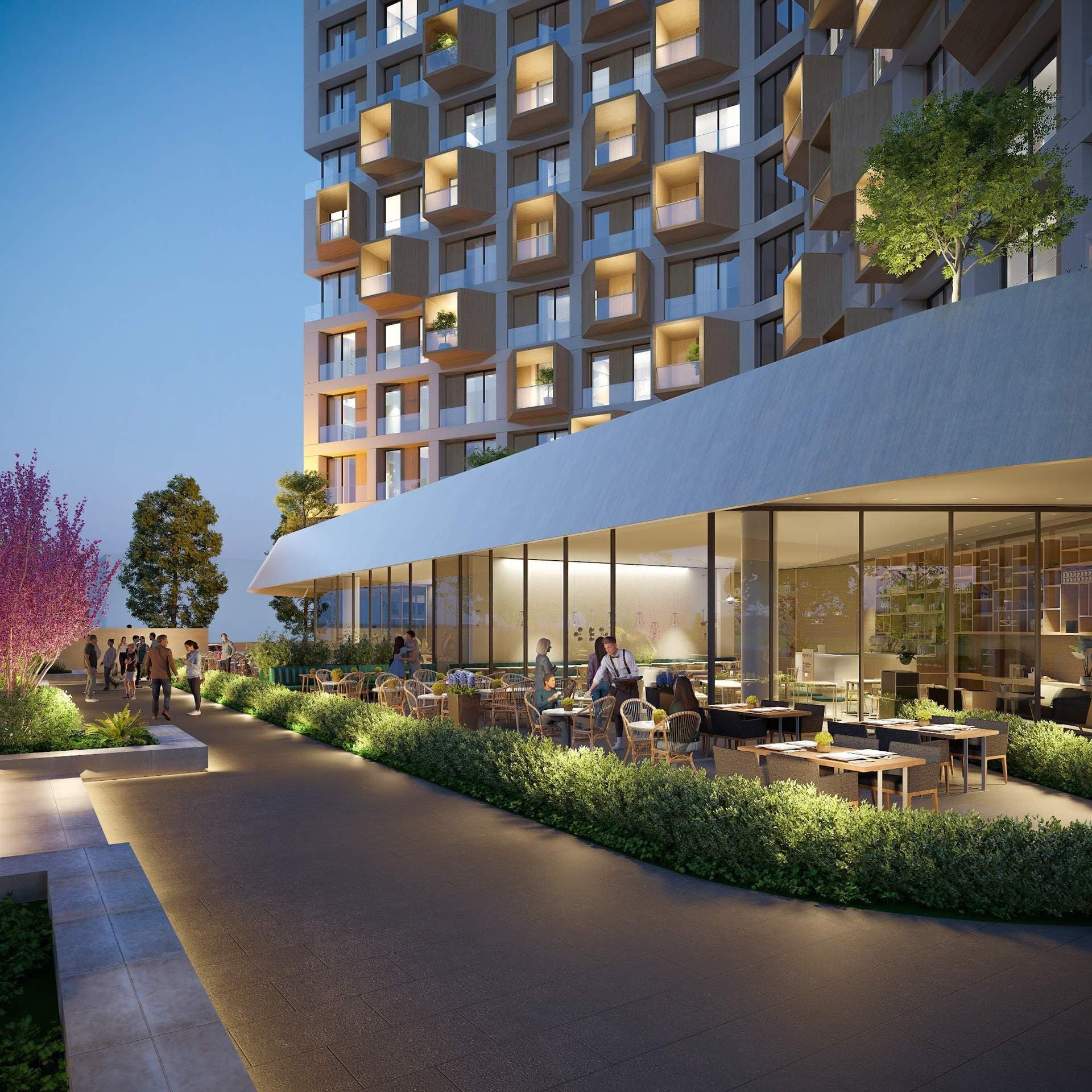 Dusk render of a landscaped walkway passing glass-fronted ground-floor restaurants with outdoor seating under the podium canopy