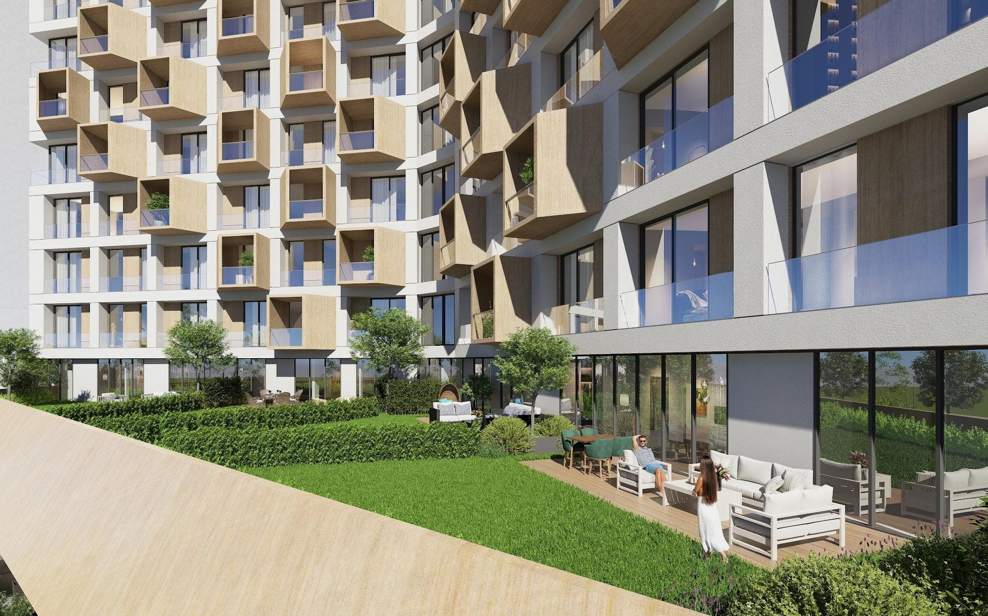 Render of a private garden with a lawn and outdoor sofas in front of a ground-level apartment terrace at the foot of the tower