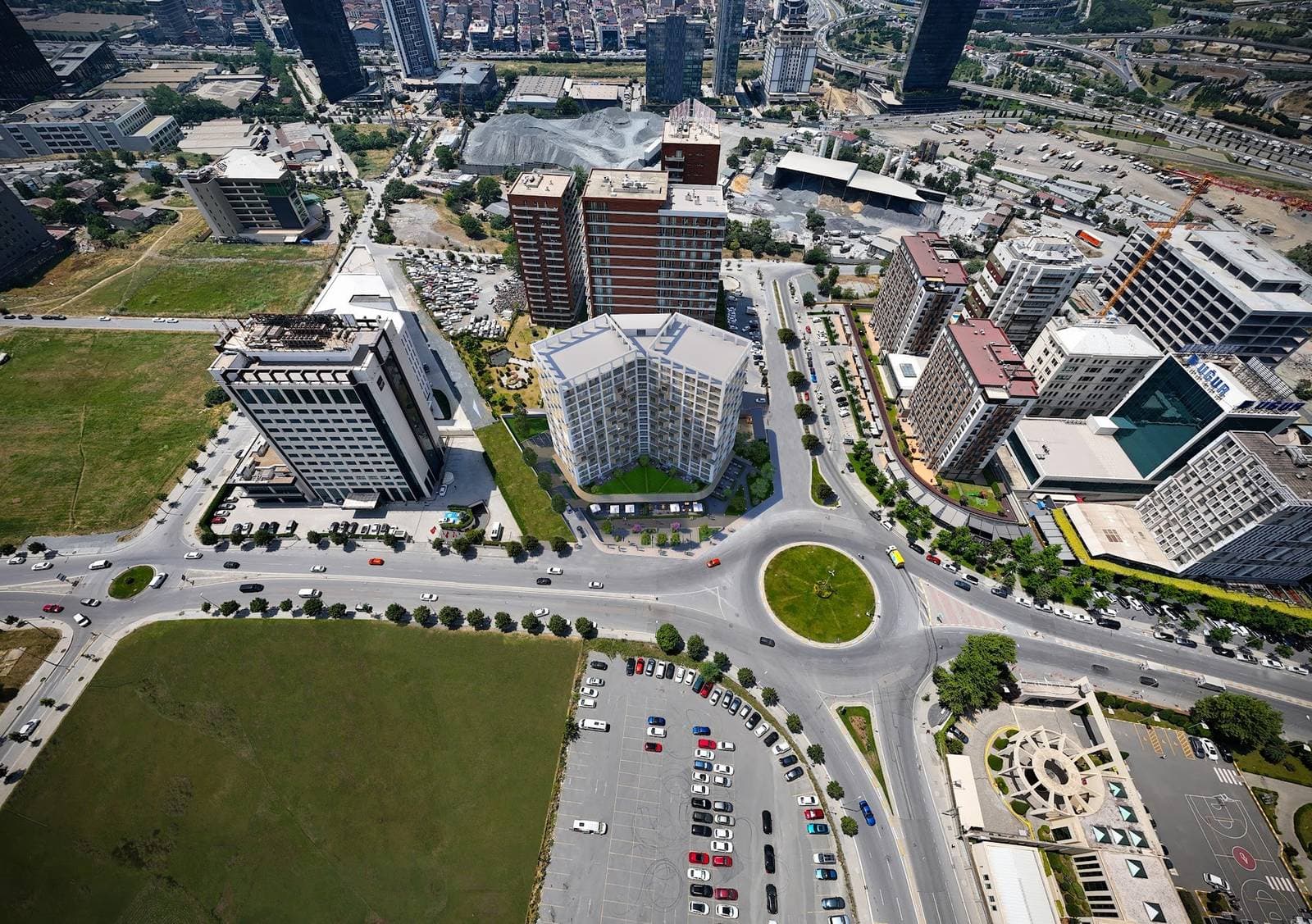 Aerial photomontage of the tower in its setting beside a roundabout in Mahmutbey, among office towers, university buildings and open land