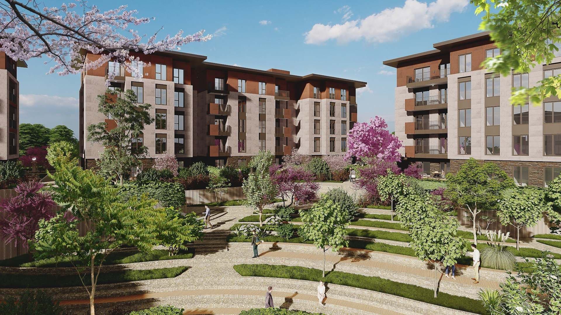 Landscaped courtyard with terraced lawns and paths between the blocks