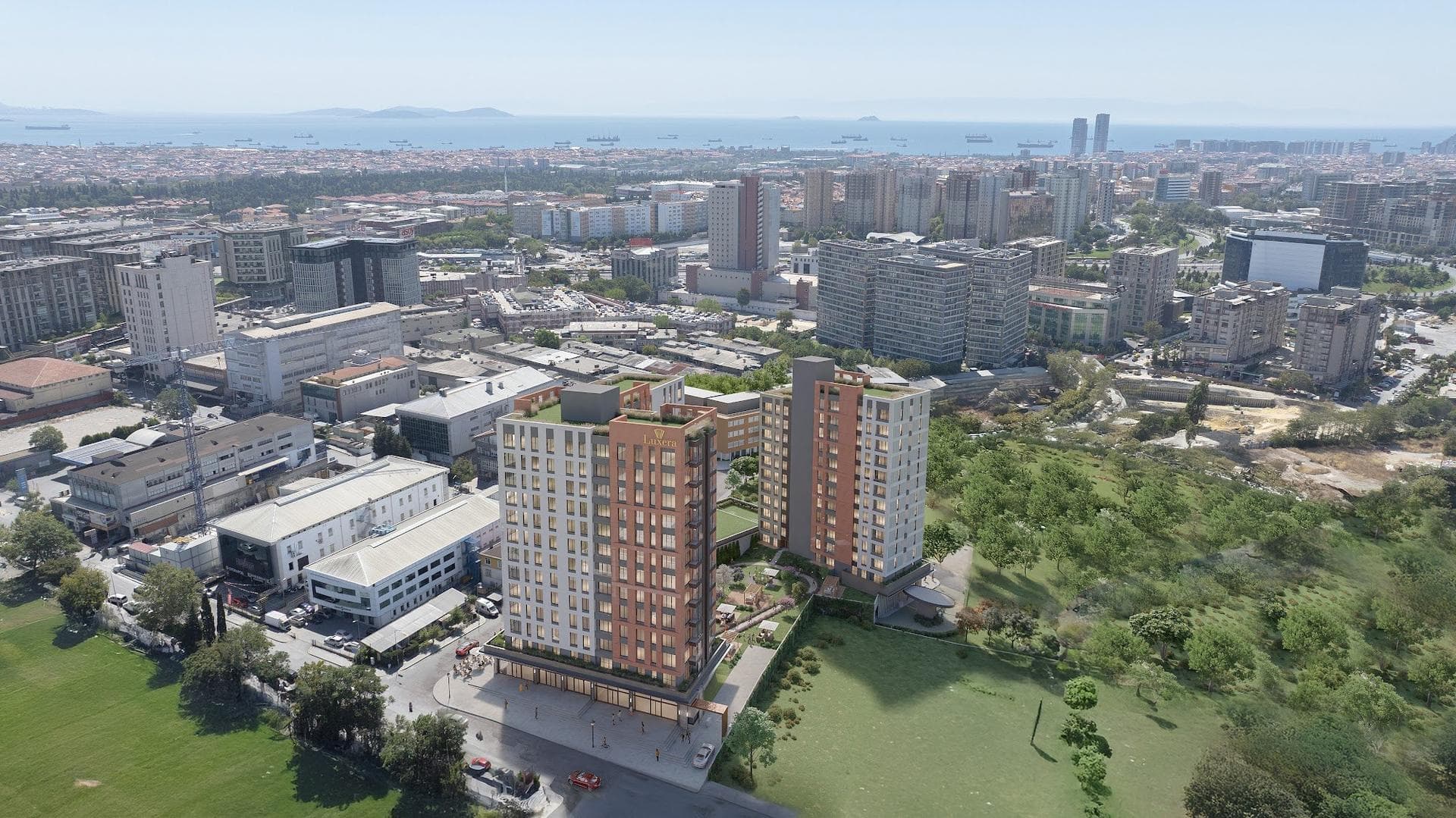 Aerial photo of the neighborhood with the project rendered in, looking across Zeytinburnu with the Sea of Marmara on the horizon