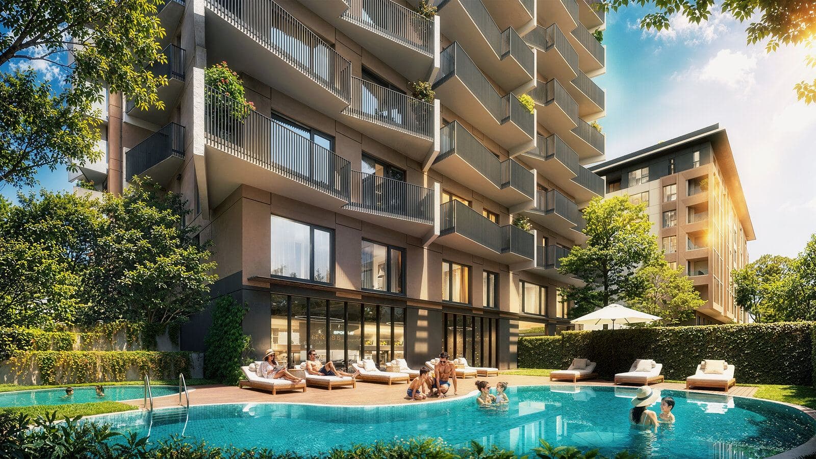 Curved outdoor pool and sun loungers at the foot of the tower, beside the glass front of the fitness center
