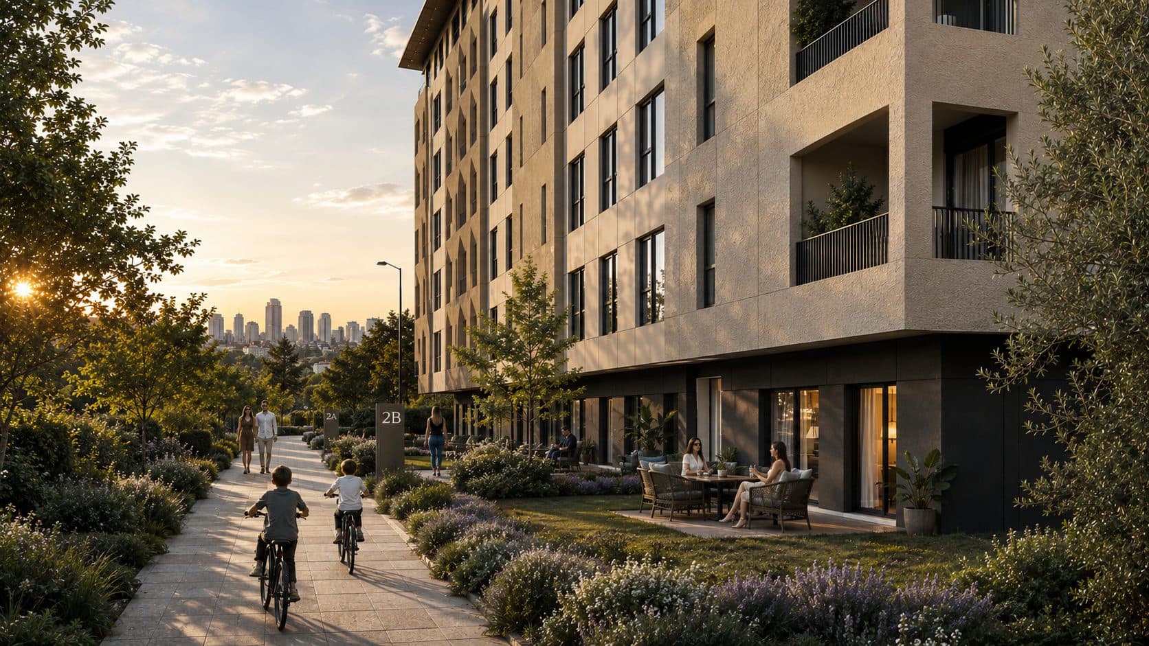 Garden-floor terraces and a path along a mid-rise block at sunset