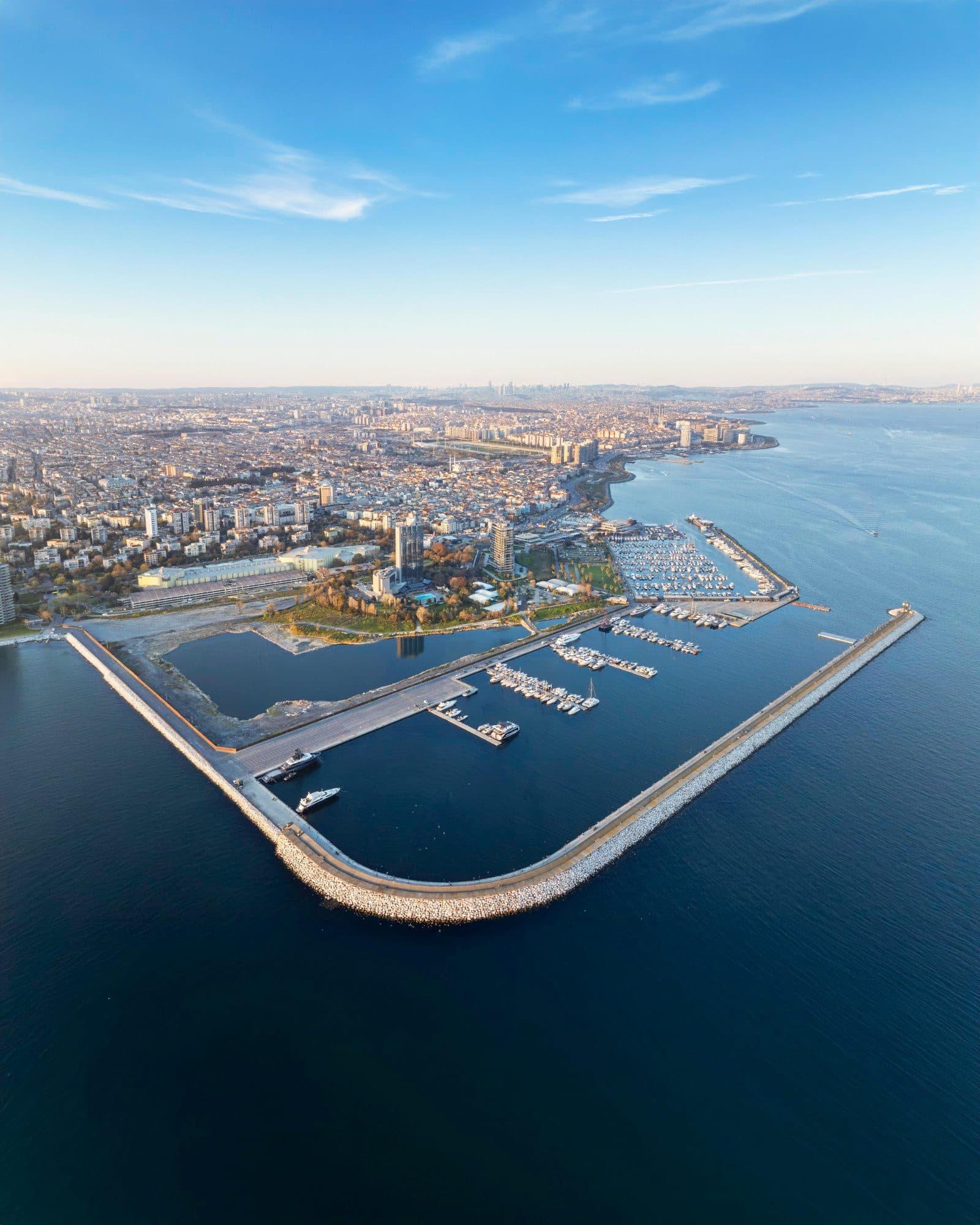 Aerial view of the marina's long breakwater and harbor basin with the Bakirkoy and Atakoy shoreline behind