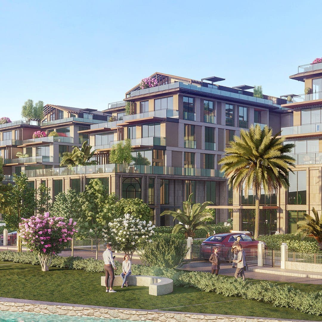 Rendered view of terraced blocks with glass balconies and roof gardens behind a lawn, flowering trees and a waterside path