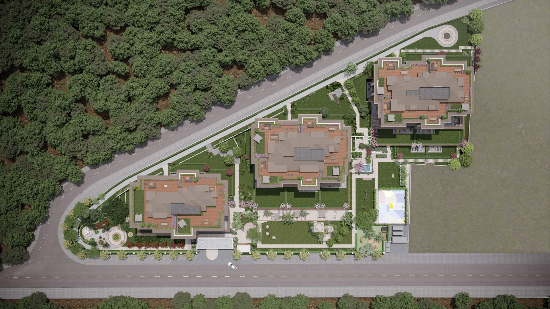 Aerial view of the three blocks and their gardens between the road and the forest
