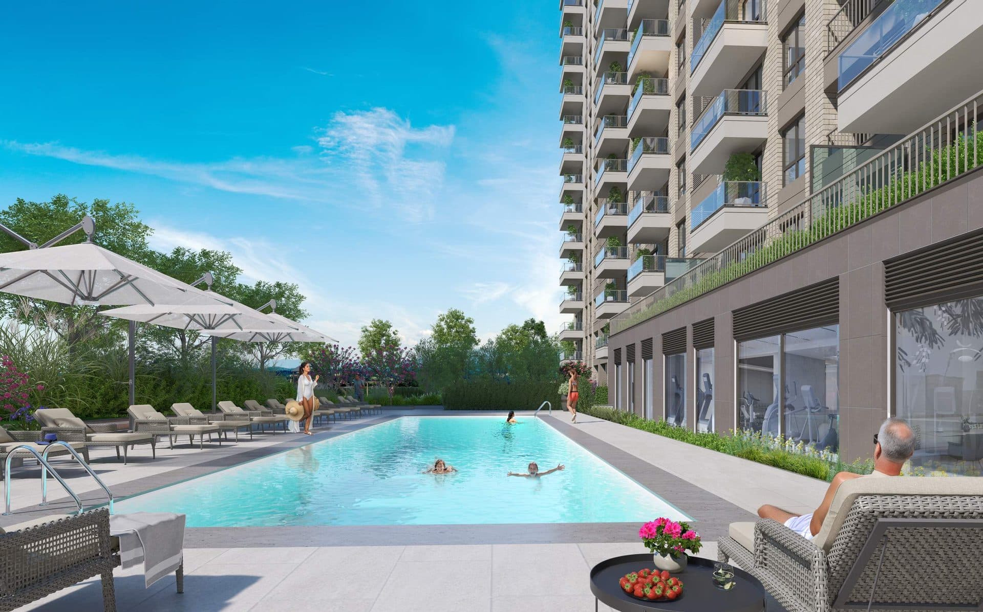Outdoor swimming pool with sun loungers beside a block