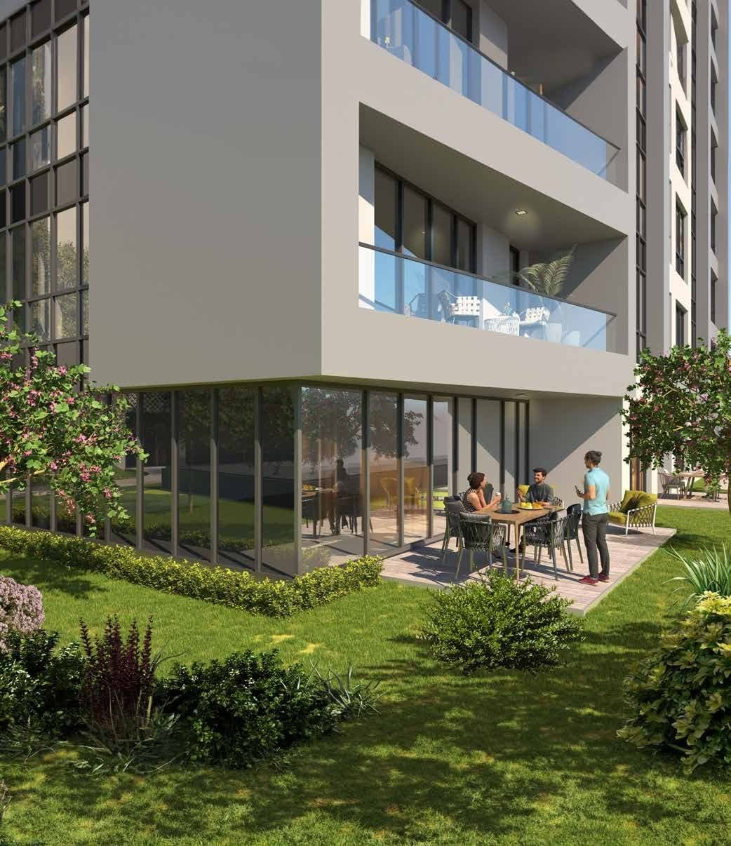 Garden-level apartment with a private lawn and an outdoor dining table at the foot of a block