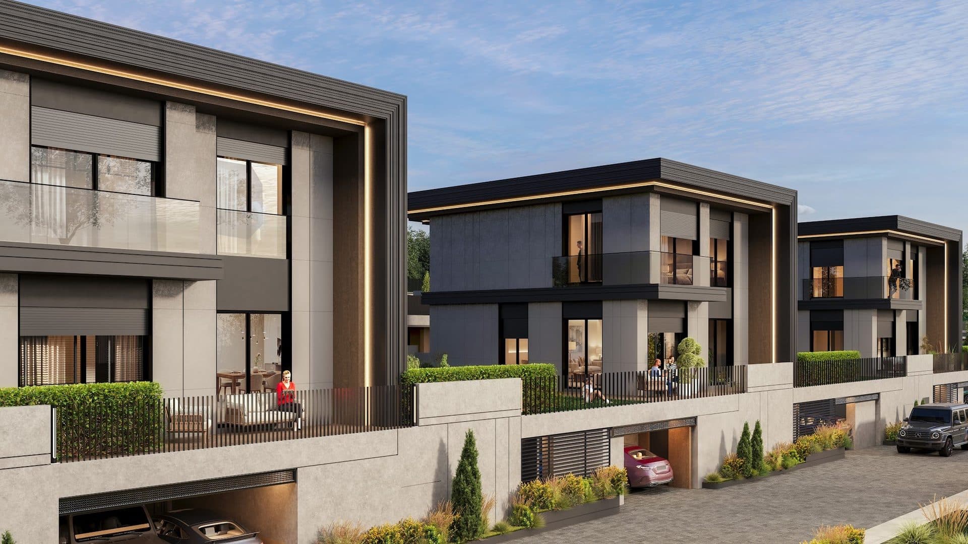 Three detached villas along the compound road, each with a fenced garden terrace above a basement garage