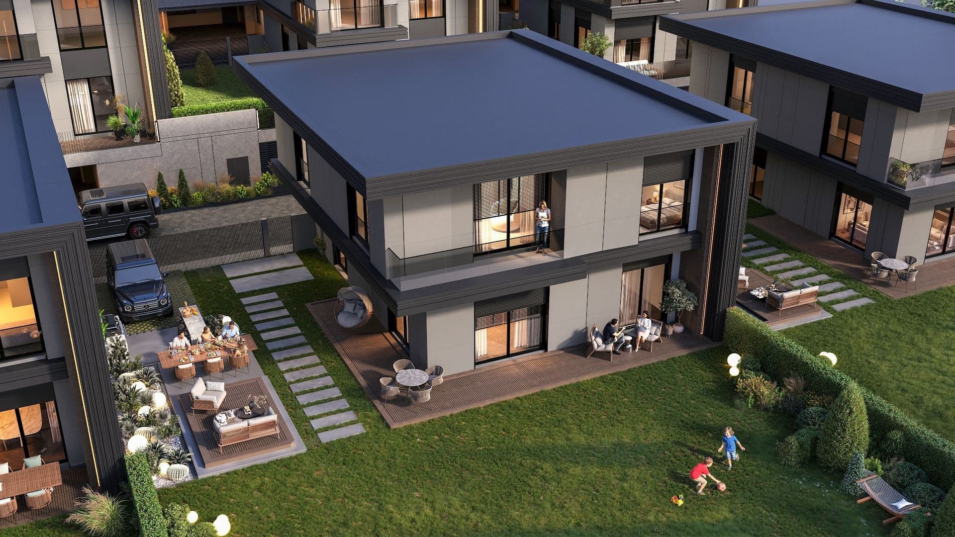 Aerial view of a villa and its private garden with a lawn, a timber deck, outdoor dining and lounge areas