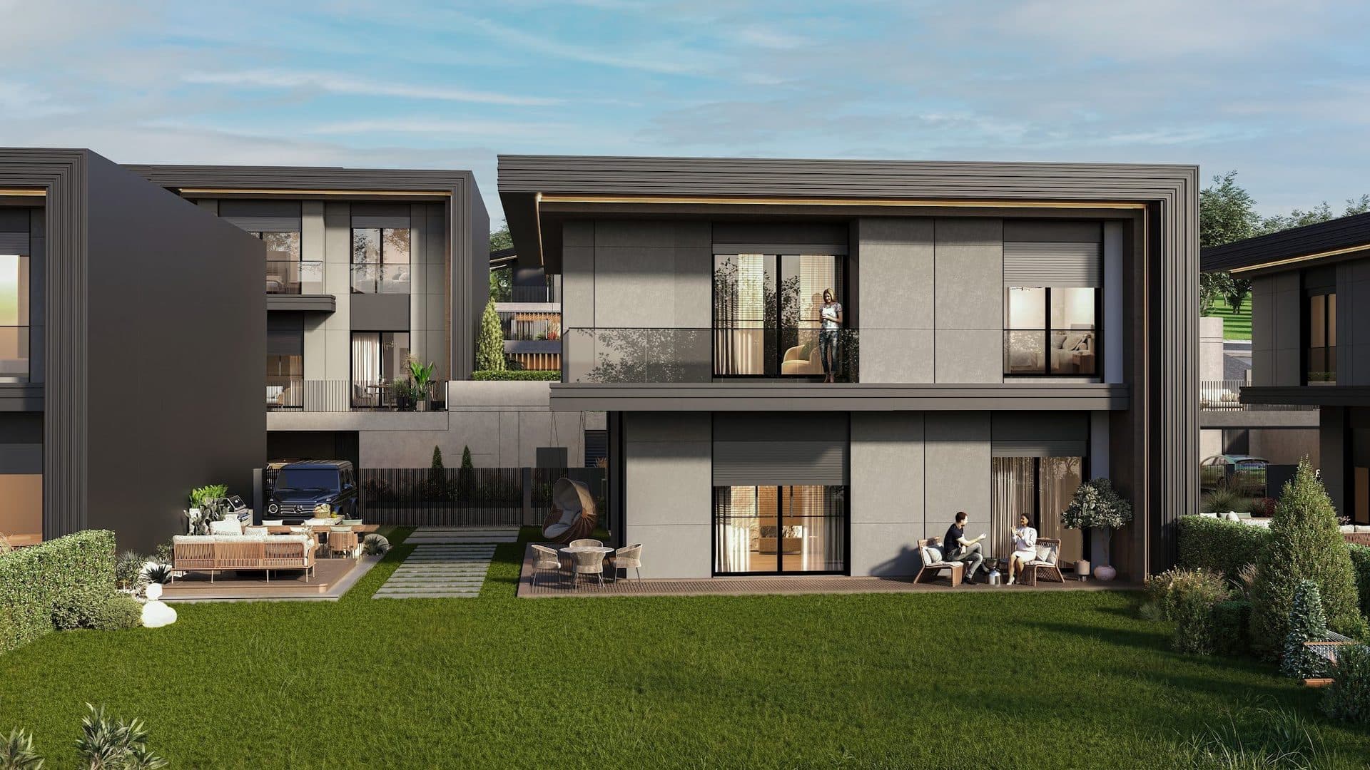Garden side of a villa with a ground-floor deck, a hanging chair and an upper-floor glass balcony over the lawn