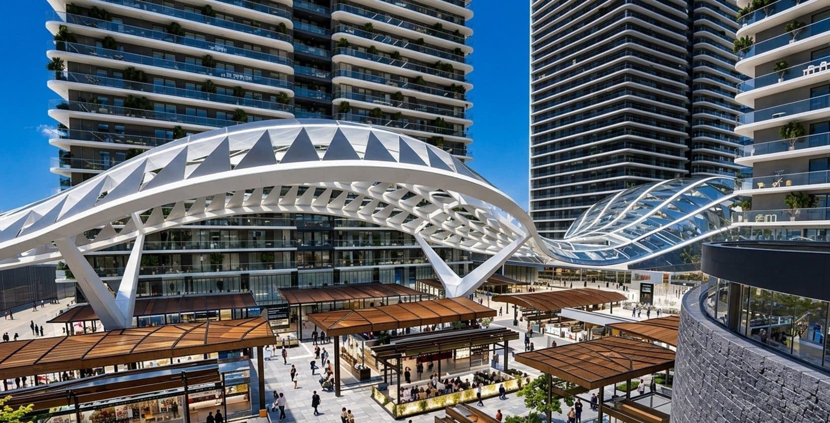 Pedestrian shopping street with open-air cafes beneath the curved white canopy between the towers