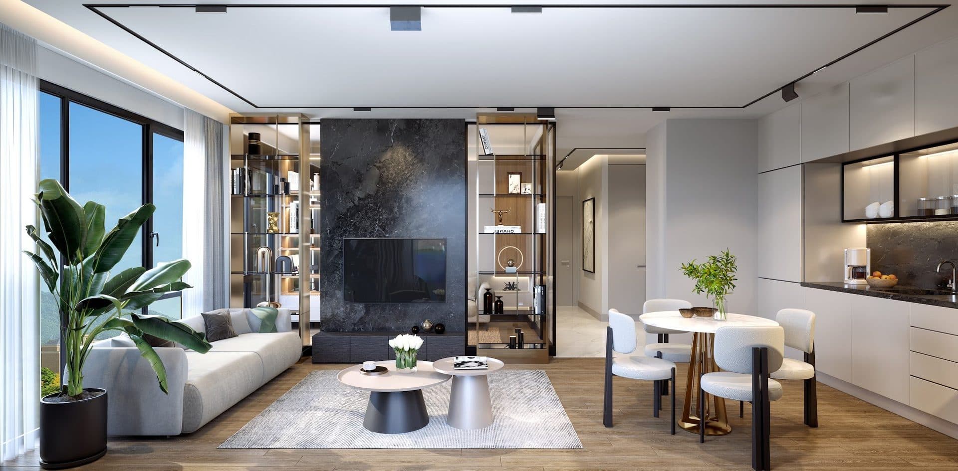 Rendering of a 2+1 living room with a grey sofa, a dark stone TV wall between glass shelving units, a round dining table and an open kitchen