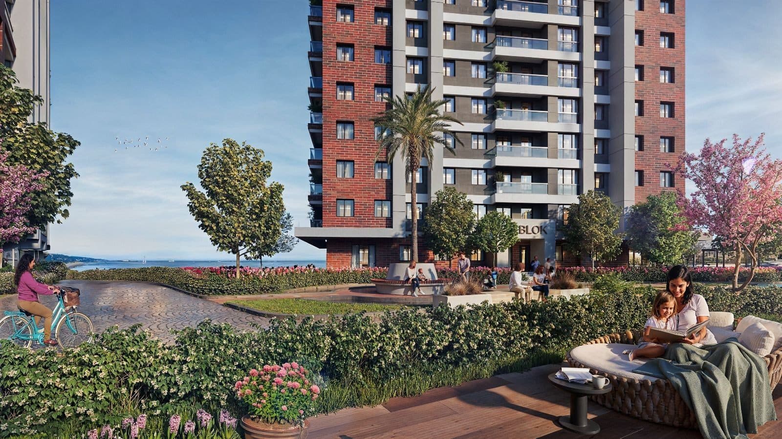 Landscaped courtyard with flower beds, a cycle path and seating at the foot of a tower